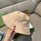 Gucci bucket hat angled view, light pink with green GG lattice pattern