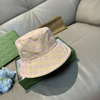 Gucci bucket hat in light pink with green GG pattern and stitched brim