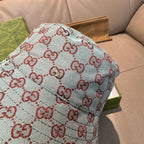 Gucci bucket hat in light blue with red GG monogram pattern, fabric detail