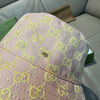Gucci bucket hat close-up of top seam with green GG monogram on pink