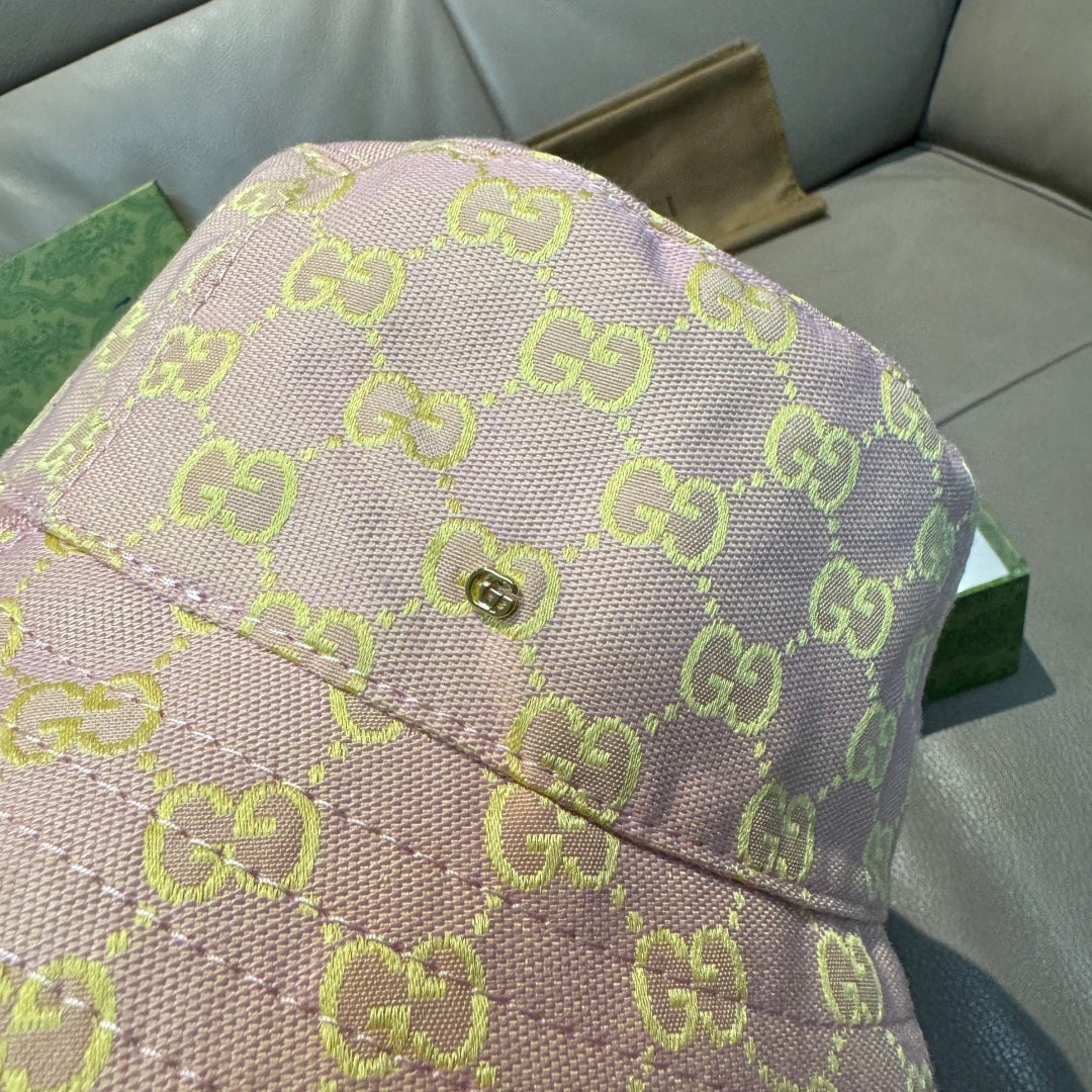 Gucci bucket hat close-up of top seam with green GG monogram on pink