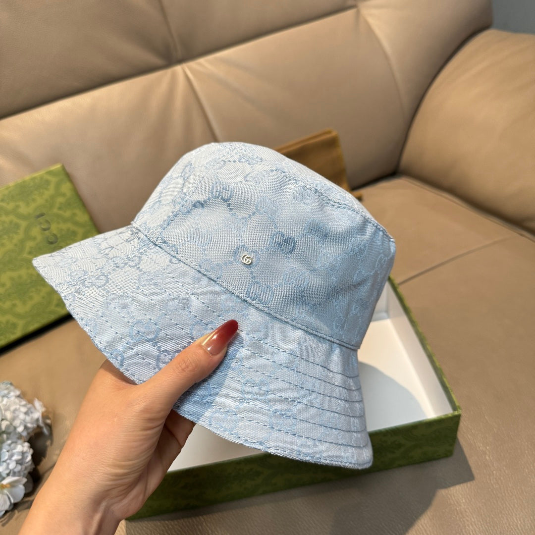 Gucci GG monogram light blue bucket cap, angled view with curved brim and front button