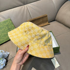 Gucci yellow GG monogram bucket hat with hanging size tag