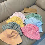 Assorted Gucci caps with pastel GG monogram patterns in pink, blue, green, yellow