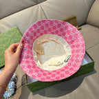 Pink bucket cap with white GG monogram pattern and beige fabric inner lining