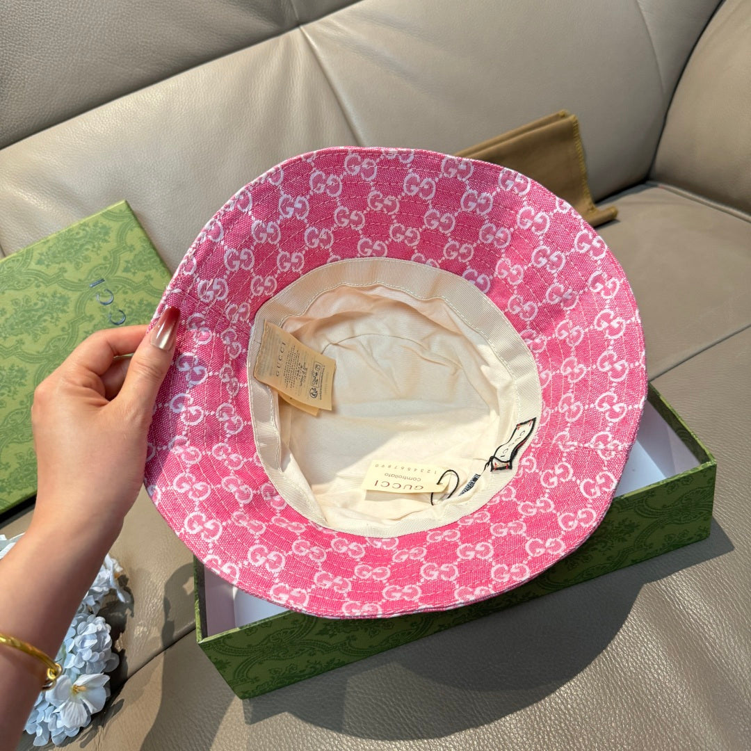 Pink bucket cap with white GG monogram pattern and beige fabric inner lining