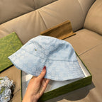Gucci GG monogram light blue bucket cap with front button and curved brim seam