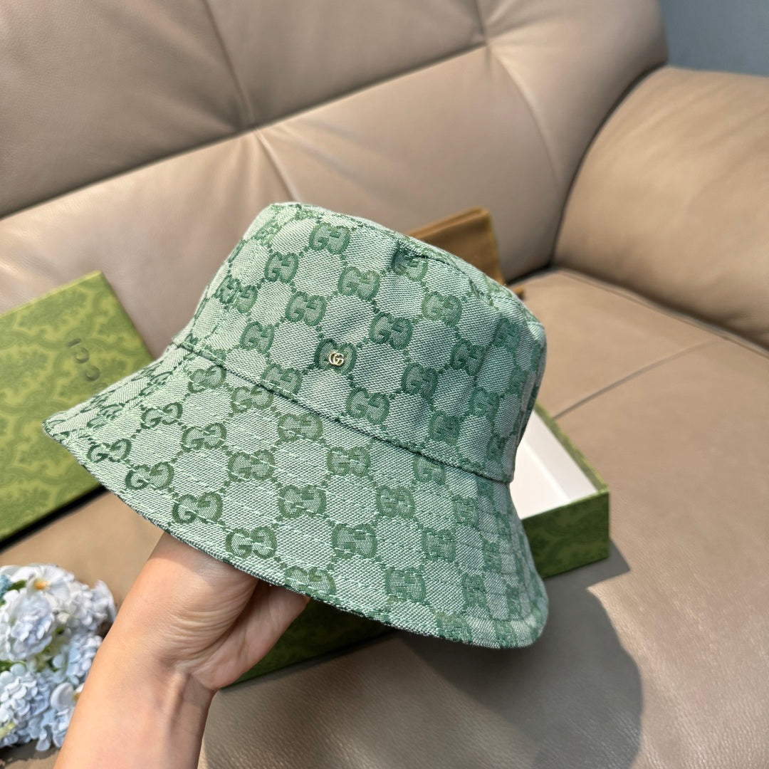 Green GG monogram bucket hat angled view with front button accent