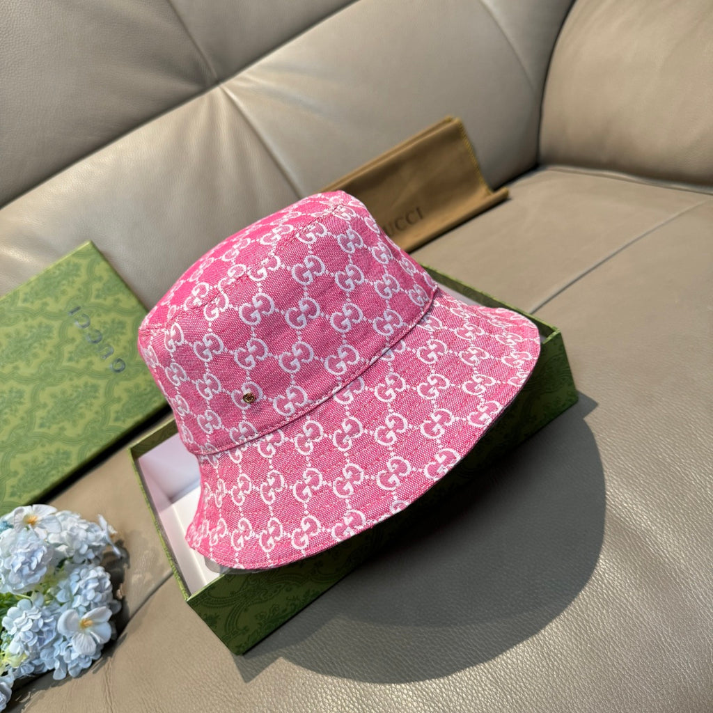 Pink Gucci-style bucket cap with white GG monogram pattern, side view