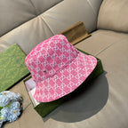 Pink Gucci-style bucket cap with white GG monogram pattern, side view