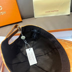 Louis Vuitton monogram cap with black interior lining and hanging size tag