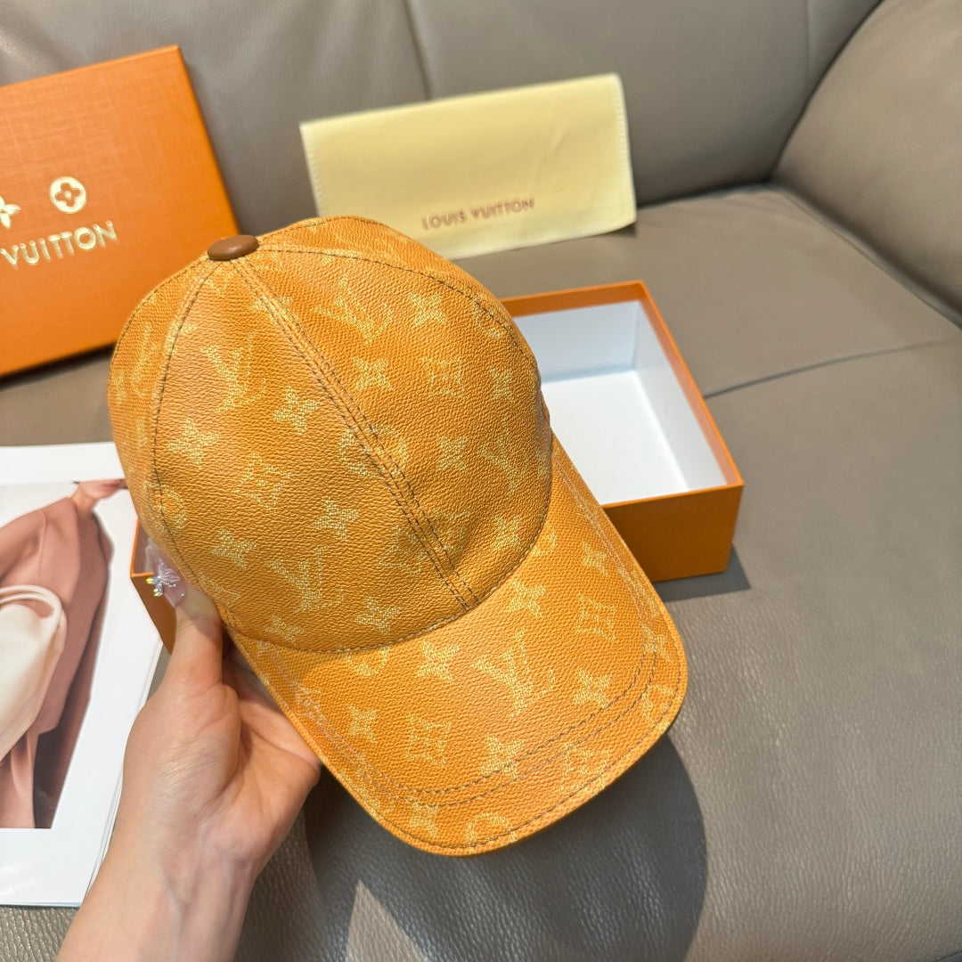 Louis Vuitton monogram baseball cap in tan/orange shown from side with curved brim