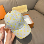 Louis Vuitton baseball cap, light blue with yellow monogram pattern and round brown button