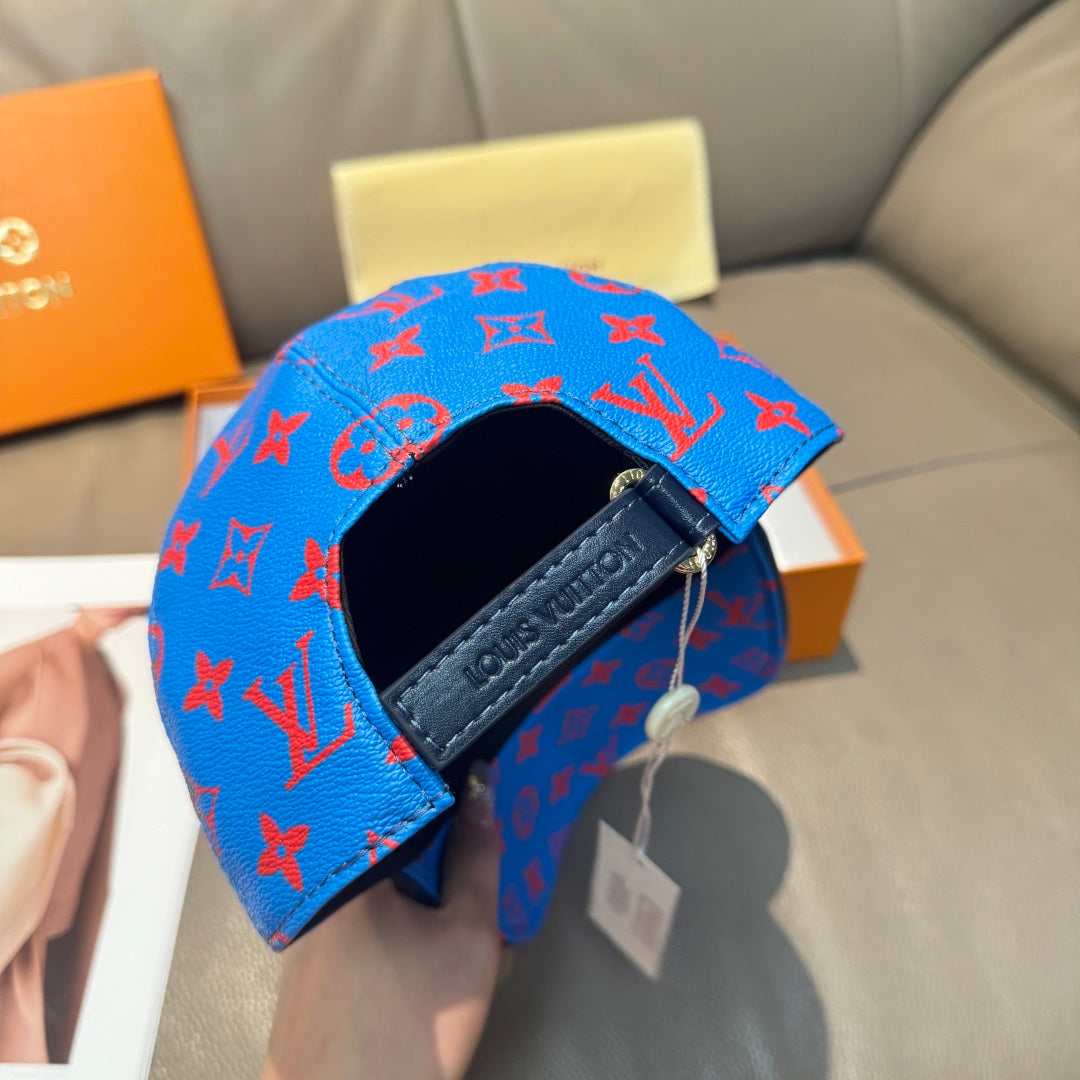Louis Vuitton cap in bright blue with red monogram pattern and leather strap detail