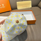 Louis Vuitton baseball cap in light blue with yellow monogram pattern and round top button