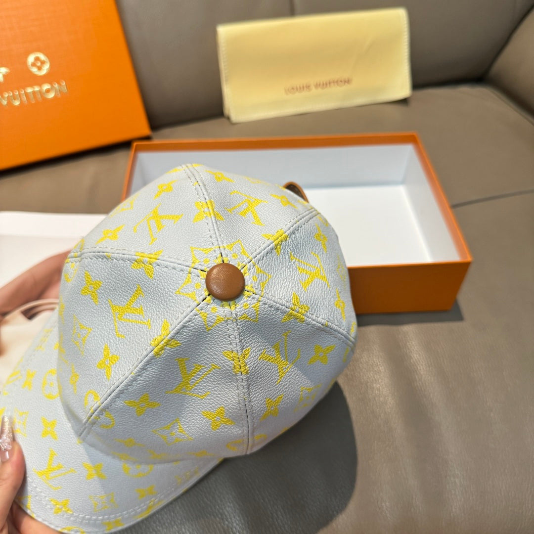 Louis Vuitton baseball cap in light blue with yellow monogram pattern and round top button