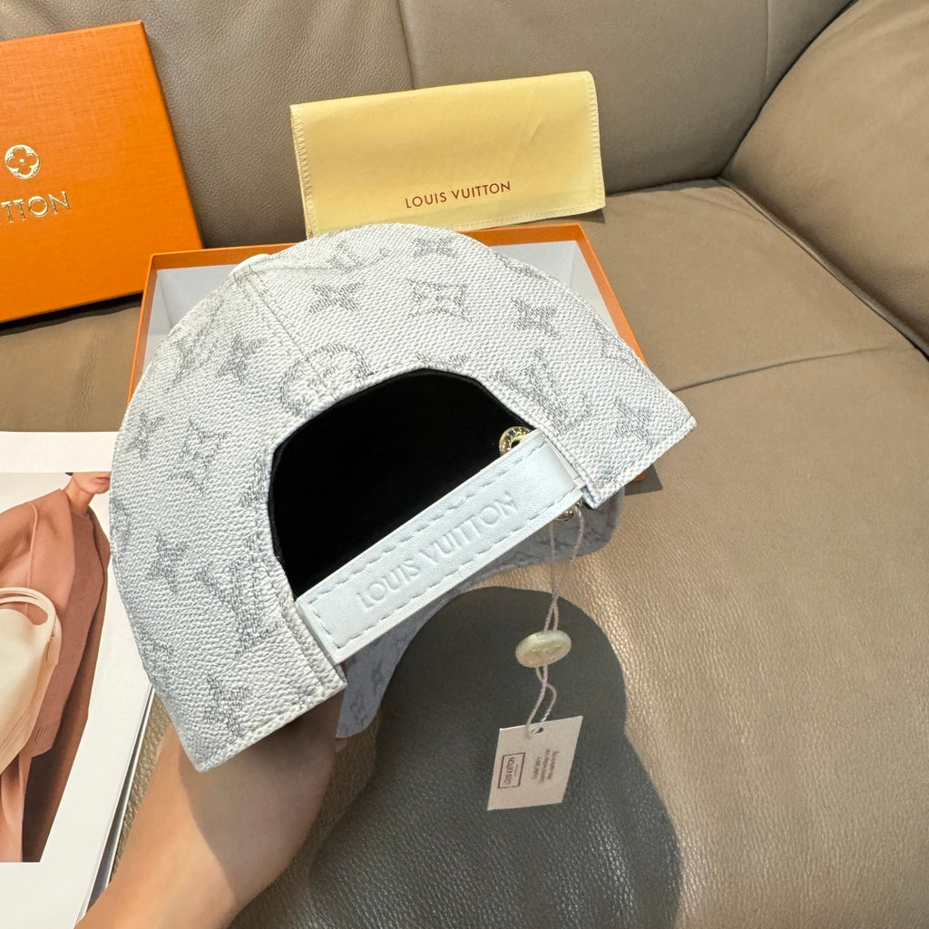 Louis Vuitton monogram baseball cap, light gray with black inner band and hang tag.