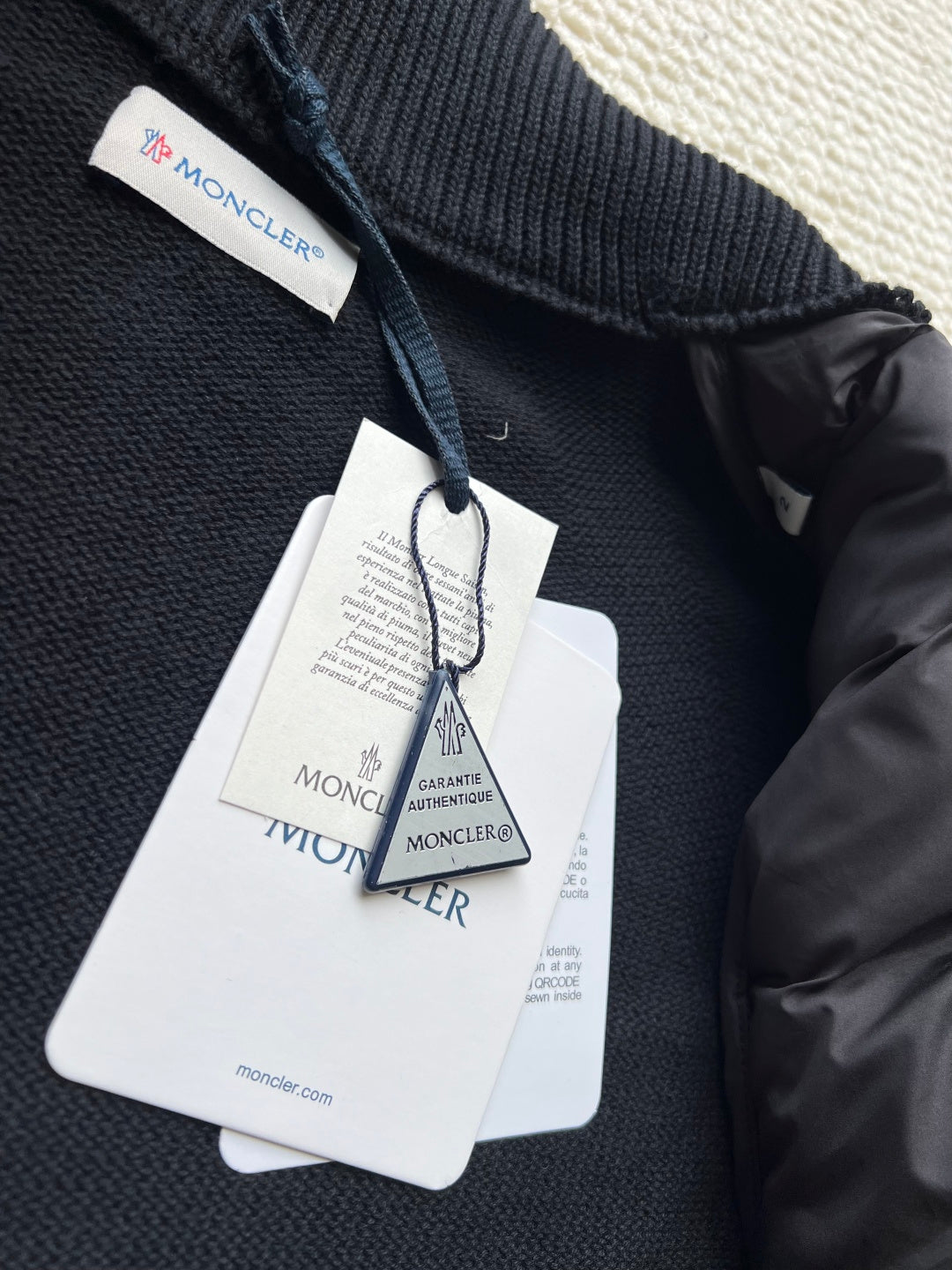 Moncler long puffer jacket interior label tags and knit collar