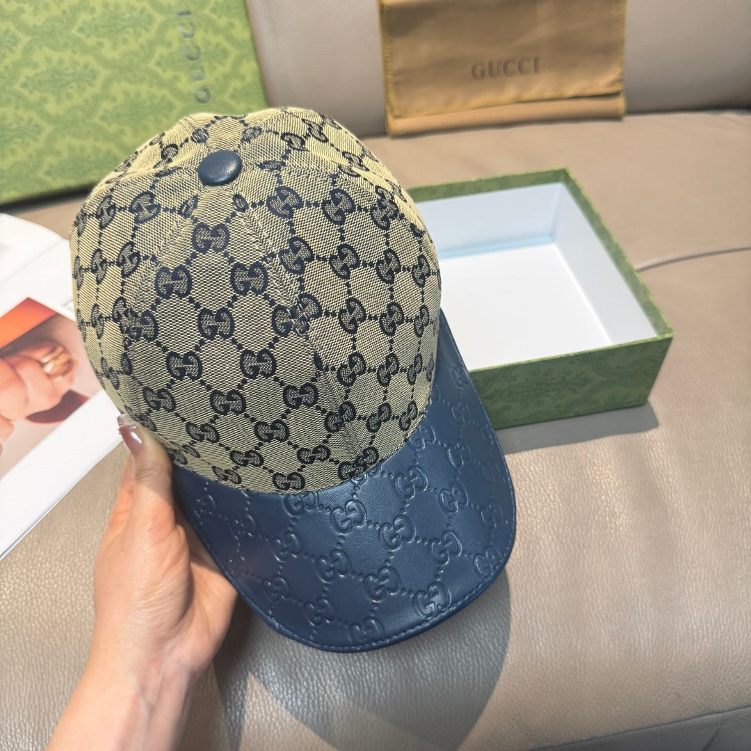 Gucci GG monogram baseball cap with dark blue leather brim, angled view
