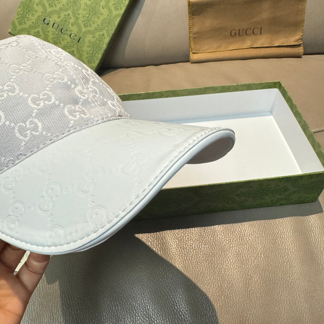 Gucci monogram baseball cap showing side panel in light gray with white logo pattern