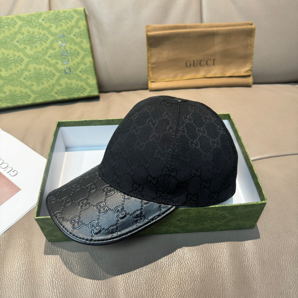 Dark navy GG monogram baseball cap with curved brim, shown on gift box