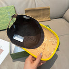 Tan GG baseball cap with black interior lining and yellow underside brim