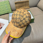 Tan GG monogram baseball cap with yellow-trim brim, front profile view