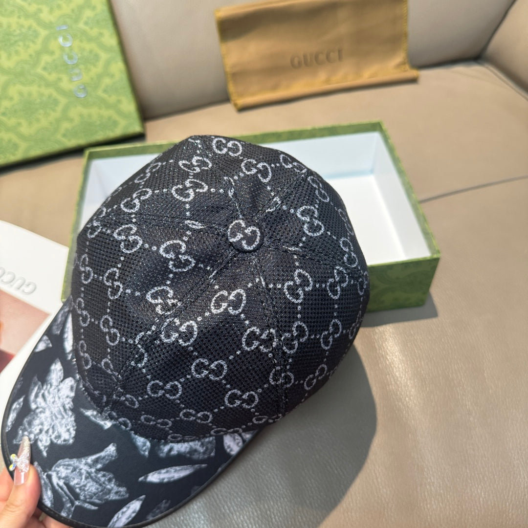 Black GG monogram cap with curved brim; front shows white floral graphic