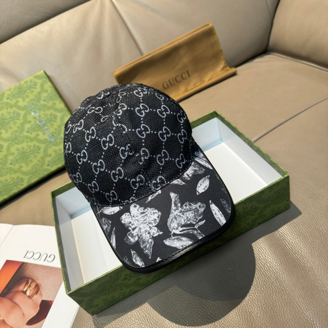 Black GG-print cap with curved brim and monochrome floral graphic panel on front