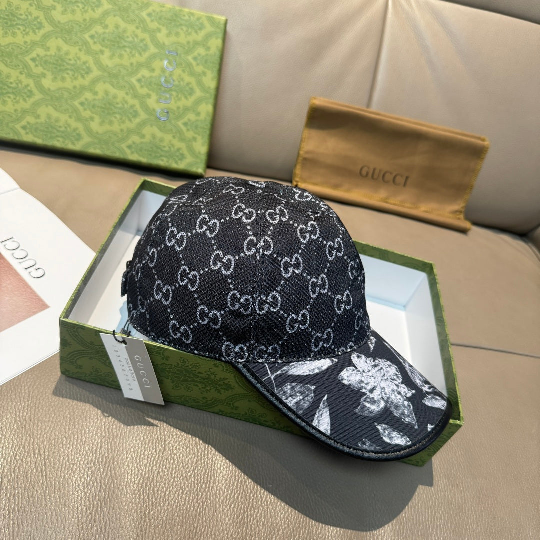 Black Gucci-style monogram cap with curved brim and white floral motif at brim edge