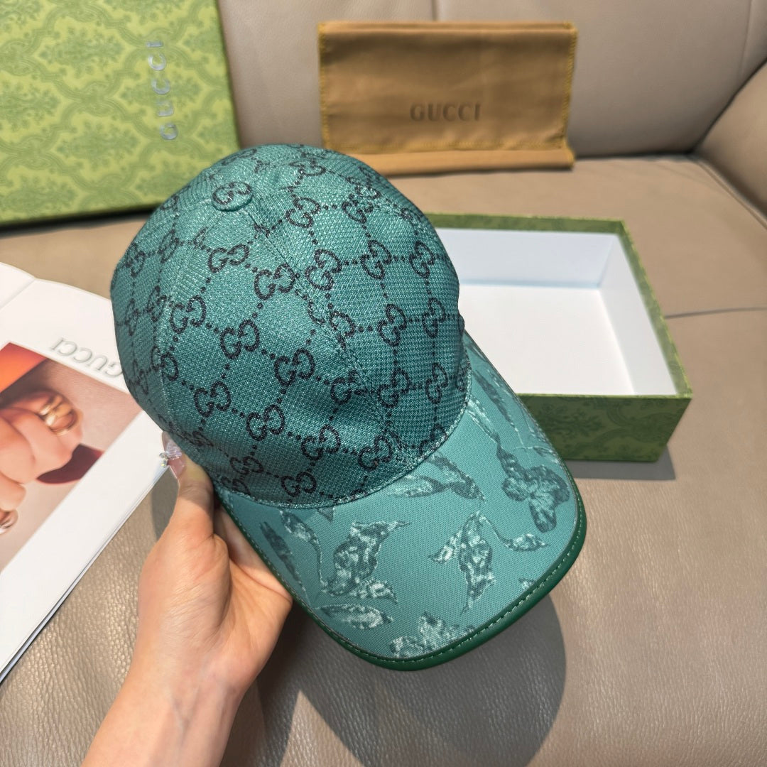 Gucci teal monogram baseball cap, side view with eagle print on brim