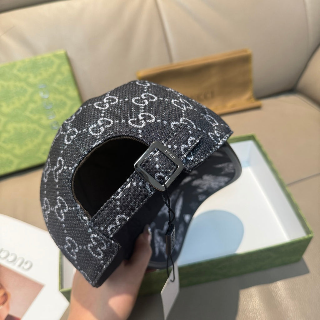 Black GG monogram cap with adjustable buckle strap across front crown
