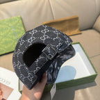 Black GG monogram cap with adjustable buckle strap across front crown