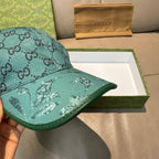 Gucci teal monogram baseball cap close-up of front panel and eagle-pattern brim
