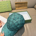 Gucci teal monogram baseball cap, top and side view with eagle print