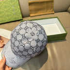 Gucci baseball cap with gray GG monogram crown and light gray/white side panel.