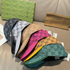 Assorted Gucci GG monogram caps in black, beige, pink, and green with curved brims