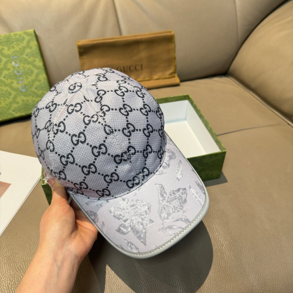 Gucci baseball cap, gray GG monogram crown and white bill with printed figures.