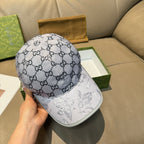 Gucci baseball cap, gray GG monogram crown and white bill with printed figures.