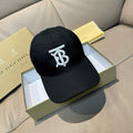 Black baseball cap with white TB logo on front, curved brim