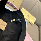 Black strap and product tag on a pink and black baseball cap, adjustable fabric strap