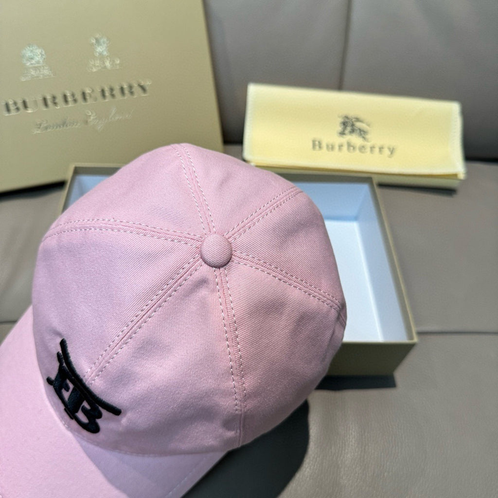 Pink baseball cap with top button detail and black TB-style logo on the front panel