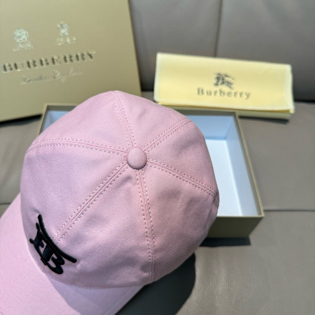 Pink baseball cap with top button detail and black TB-style logo on the front panel