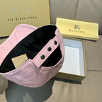 Pink baseball cap with black inner brim and side strap with metal snaps