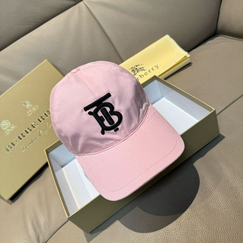 Pink baseball cap with black TB-style logo patch, curved brim and stitched crown