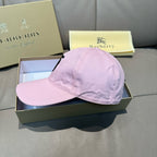 Pink baseball cap viewed from the side, curved brim and stitched crown in pink