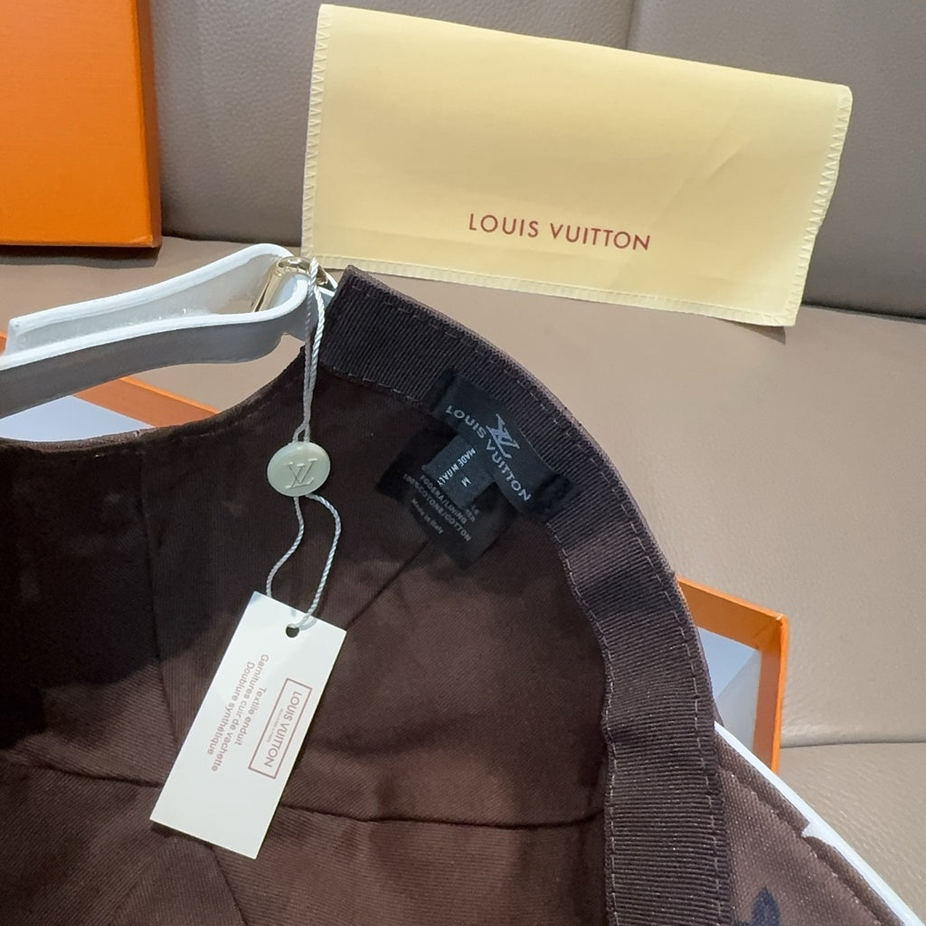 Dark brown Louis Vuitton monogram baseball cap with adjustable strap and interior label