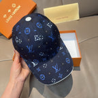 Louis Vuitton navy baseball cap with blue monogram pattern and white button at crown