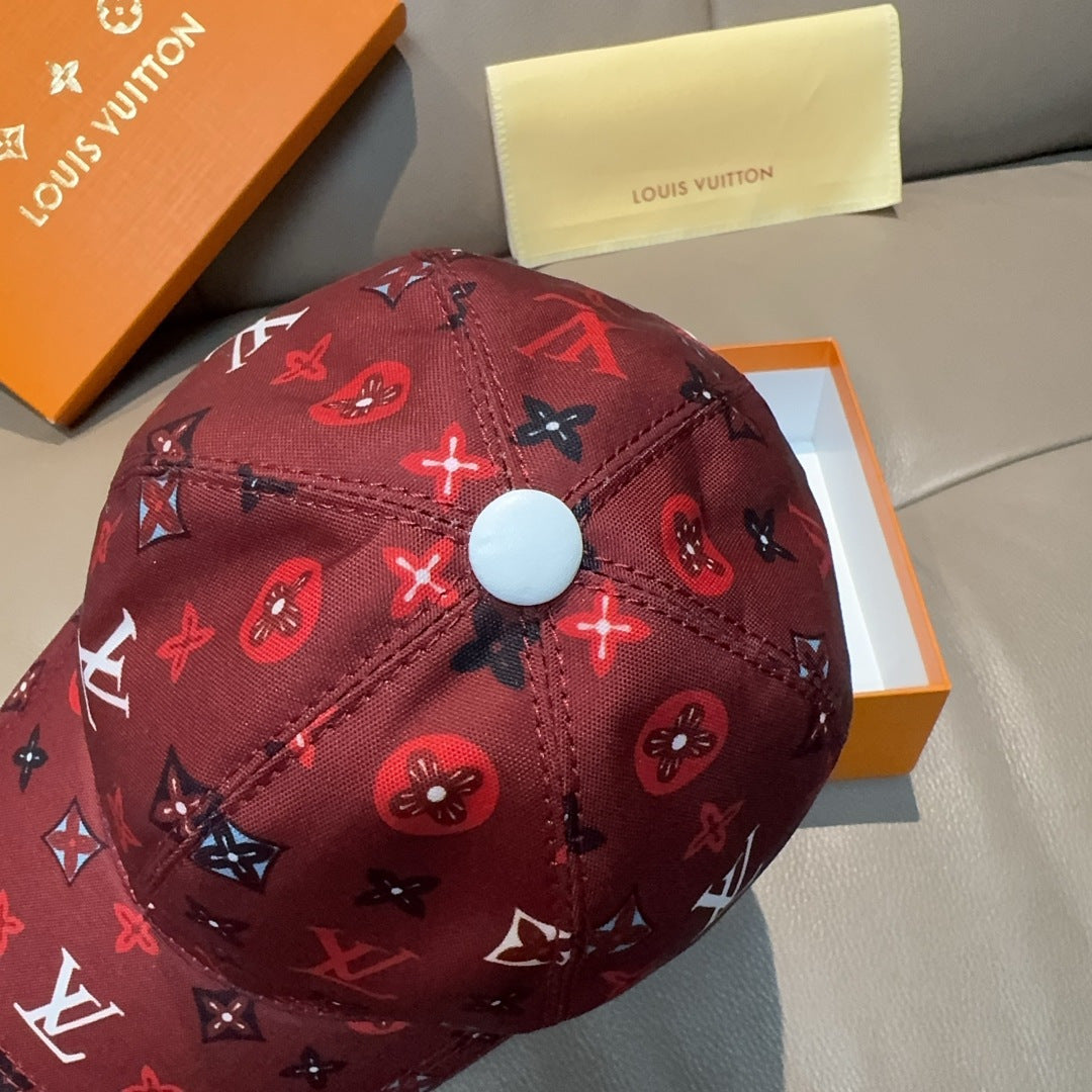 Louis Vuitton cap close-up, dark red monogram print with round top button.
