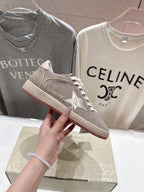 Golden Goose gray low-top sneaker with red-trim outsole, lace-up